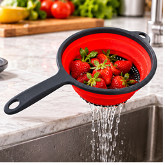 Colador de silicona plegable rojo ambientado en cocina