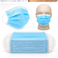 Tapabocas desechables azules apilados y mascarilla colocada en un maniquí