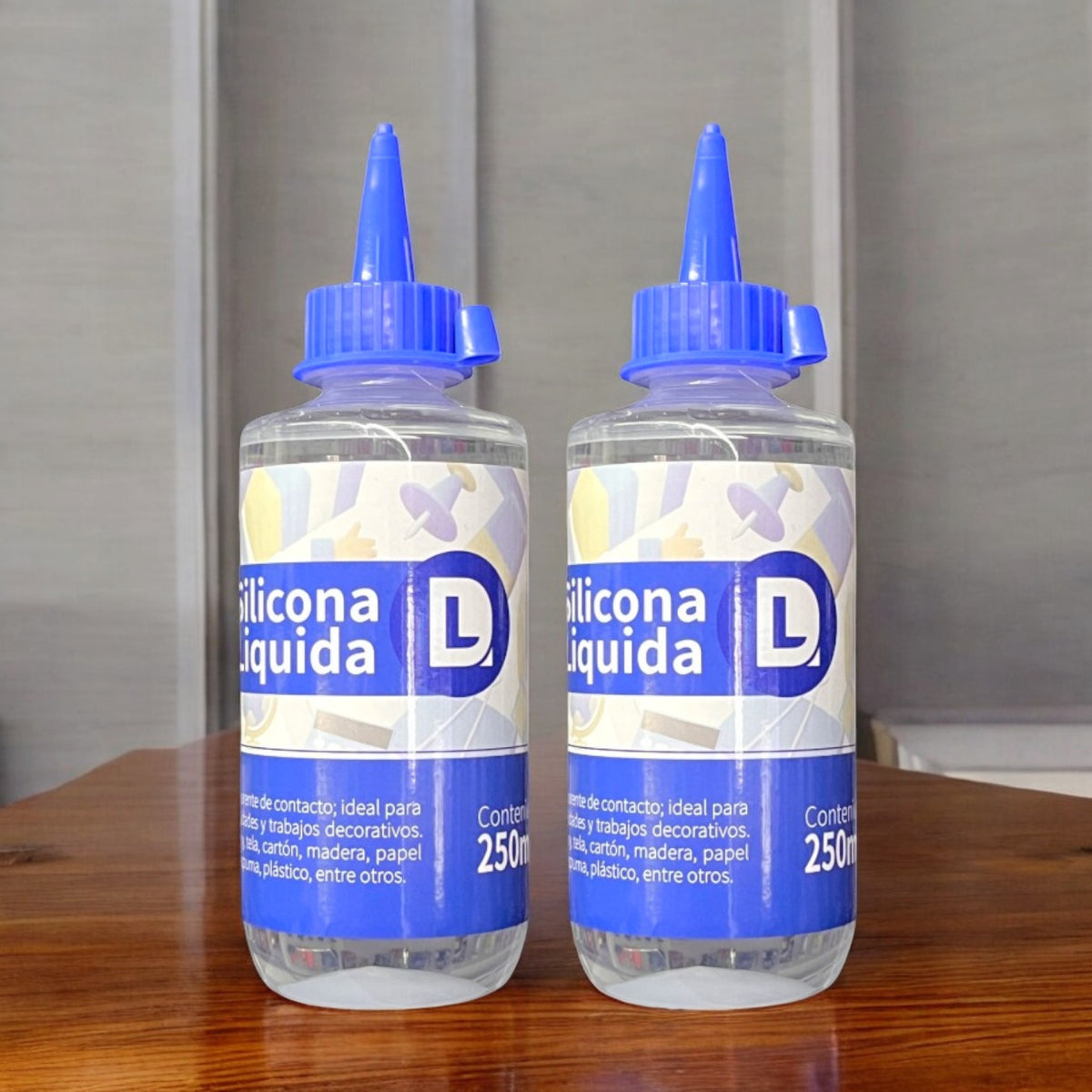 Dos botellas de silicona líquida azul con boquilla, vista frontal