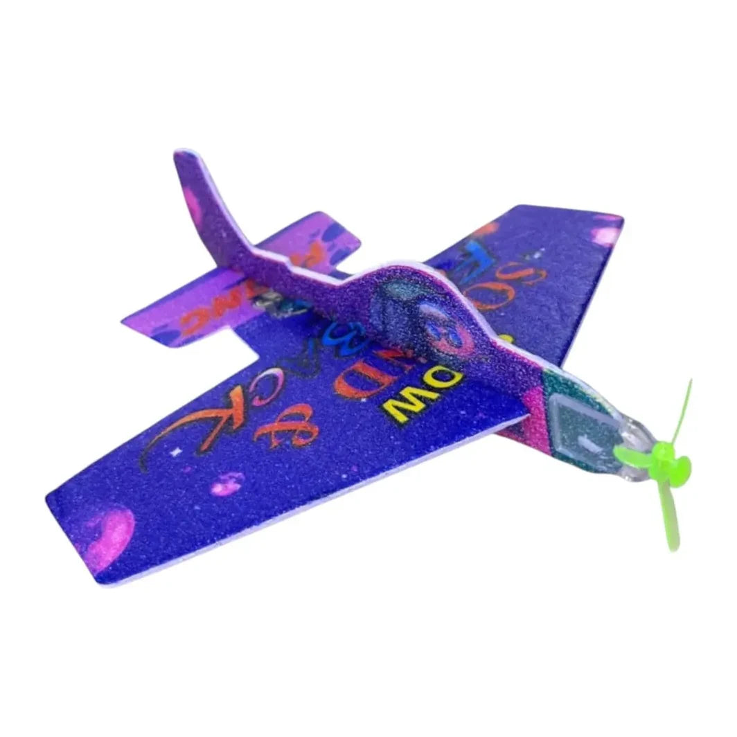Avión de juguete YJ036 de espuma morada, vista oblicua con hélice verde frontal.