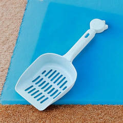 Pala perforada azul para recoger desechos de mascota