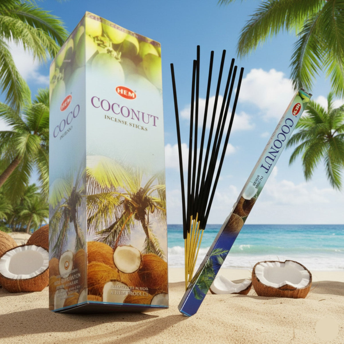 Caja HEM Coco y varillas de incienso frente a una playa con palmeras y cocos.
