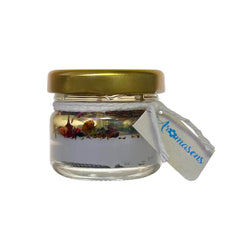 Vela aromatizante Aromasens en frasco pequeño transparente con tapa dorada, incluida en el Kit Mini Mamás.